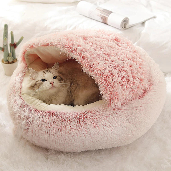 Fluffy cat peeking out of a plush cave bed