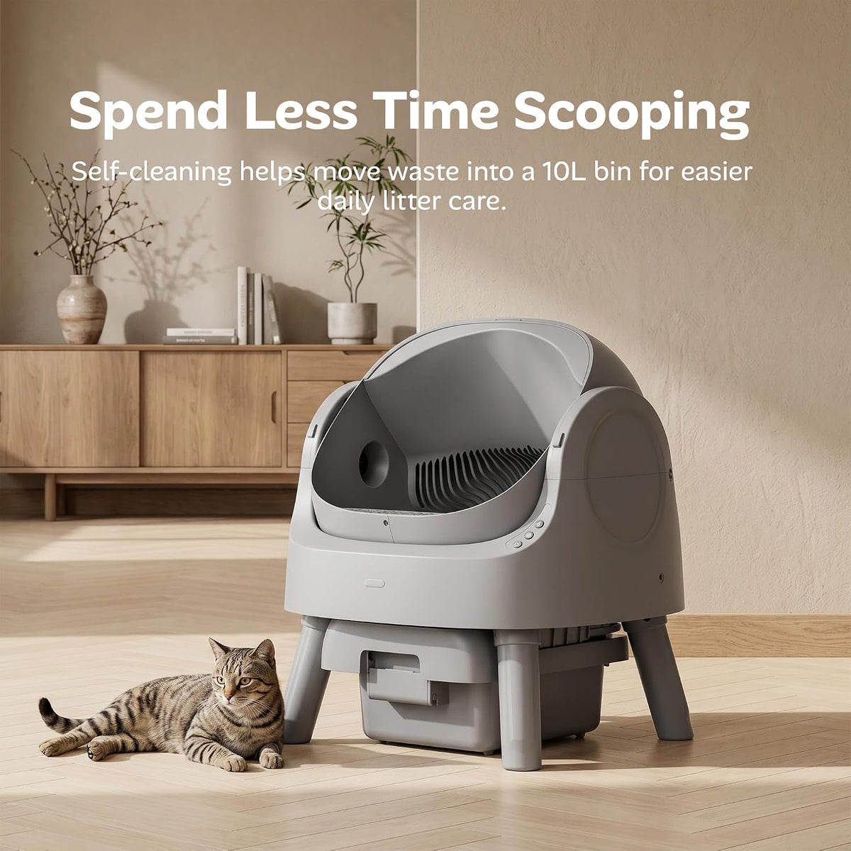 Self-cleaning litter box in a living room with a cat lying next to it